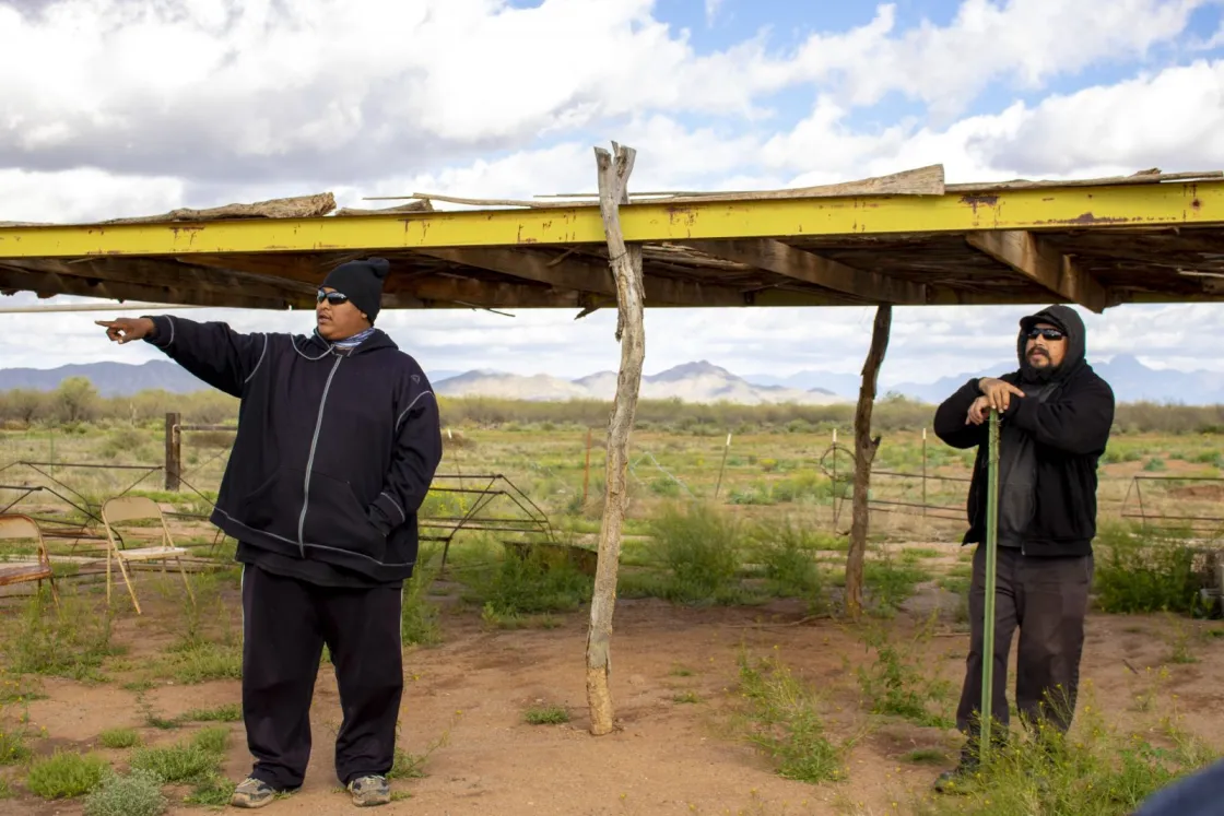 Jesse Garcia from Tohono O'odham Community Action orientes IFKN visitors to landscape features on the farm.