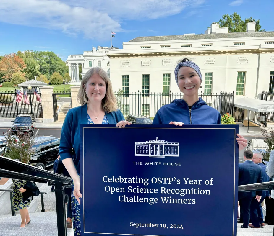 Standing with recognition poster at White House