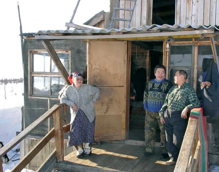 Akulina Kemlil, Grigory Velvin and Yegor Nutendli enjoy the spring sun at the Krasnushka base camp of the Nutendli community in March 2005. 